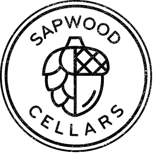Logo for Sapwood Cellars featuring a circular stamp design with an acorn and hop hybrid illustration.