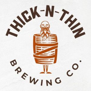 Logo for Thick-N-Thin Brewing Co. featuring a cartoon man with a long beard standing inside a wooden barrel.