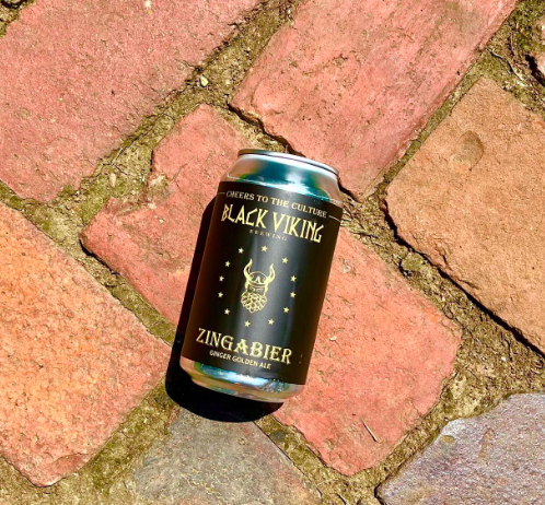 A can of Black Viking Brewing Zingabier ginger golden ale lying on a brick surface.