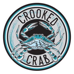 Circular logo for “Crooked Crab” featuring an illustration of a blue crab with two sailing ships depicted on its shell.